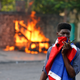 Thousands of protesters clashed with police Friday in Haiti as they looted stores the resignation of the country’s president.